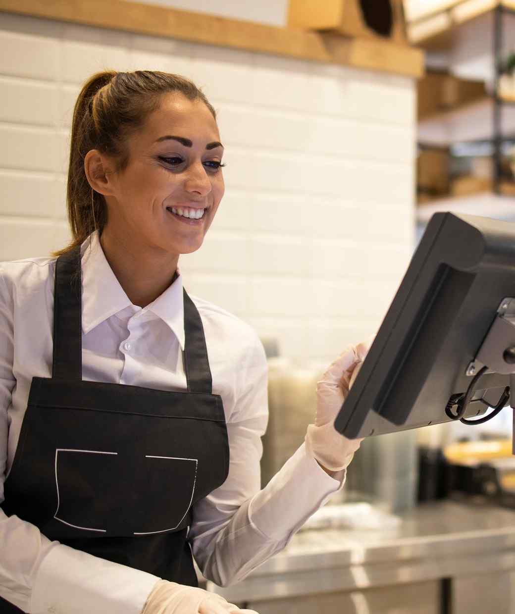 Restaurant team member using POS terminal